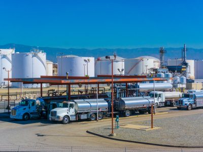 Fuel tanker trucks at refinery fueling station, CA