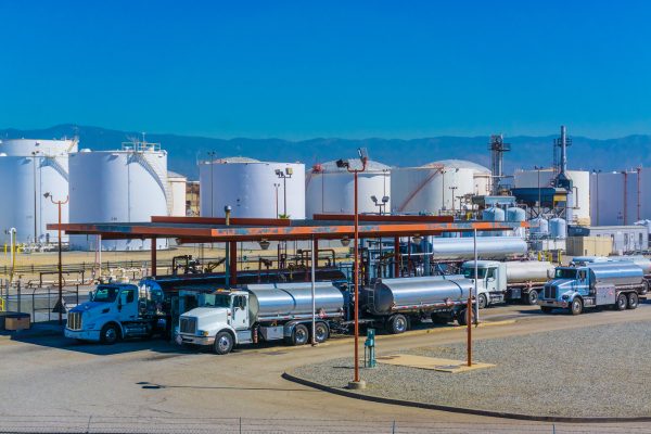 Fuel tanker trucks at refinery fueling station, CA